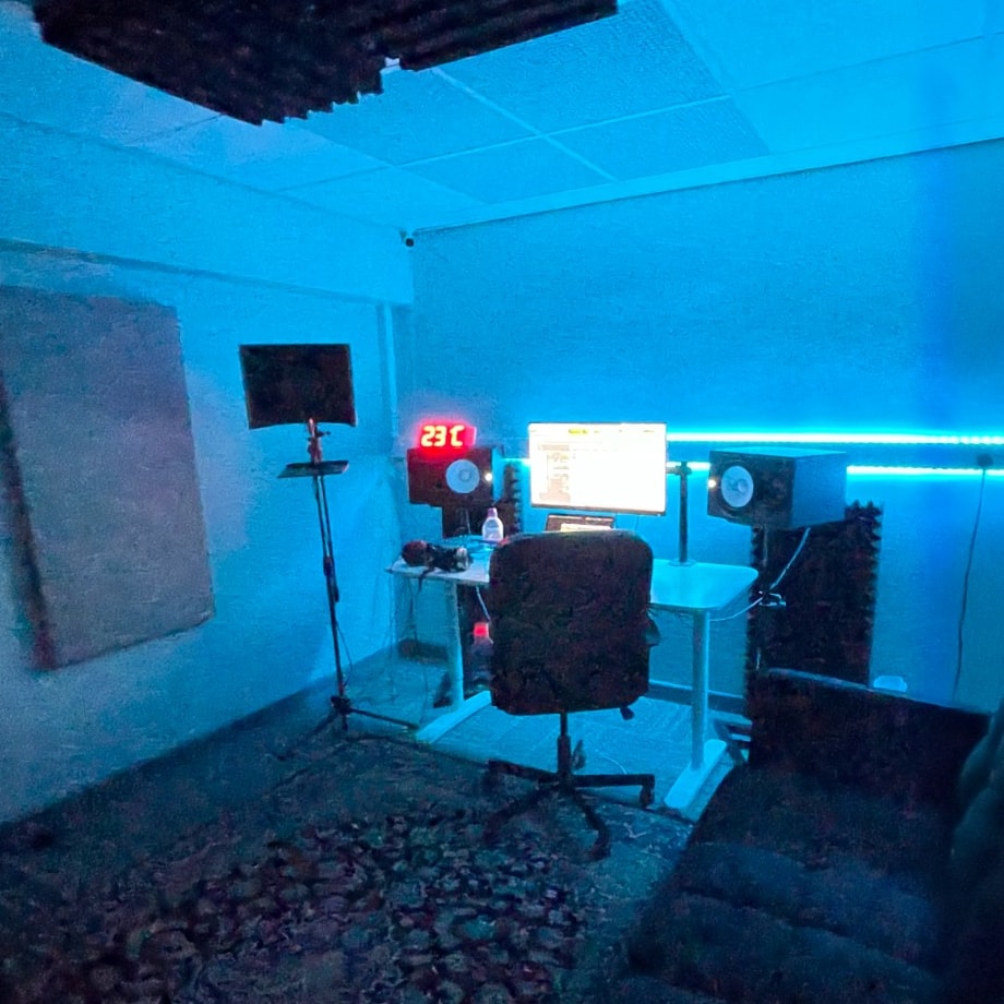 Warrington Music Studio control room with blue LED lighting, production desk, and Yamaha monitoring