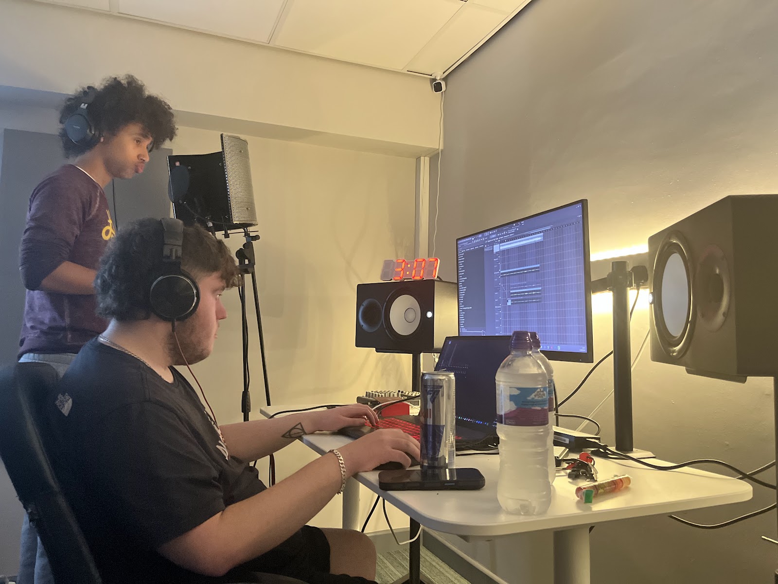 Two people working a session at the production desk