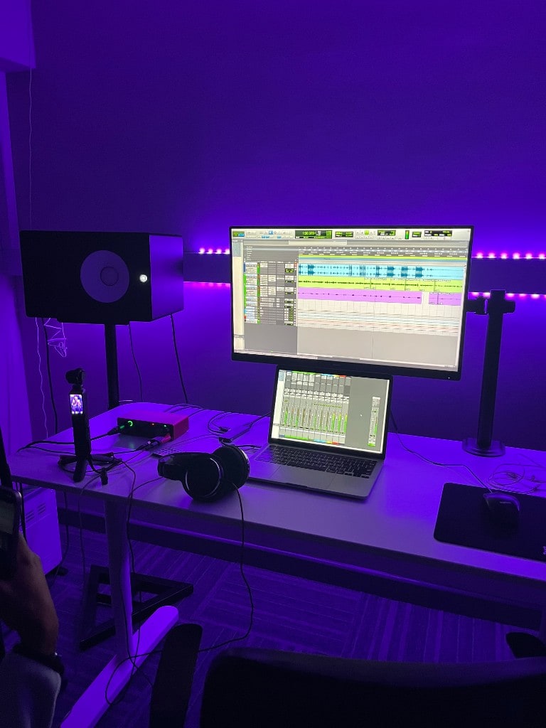 Multitrack DAW session on screen at Warrington Music Studio with Focusrite Scarlett interface, Yamaha monitor, and studio headphones.