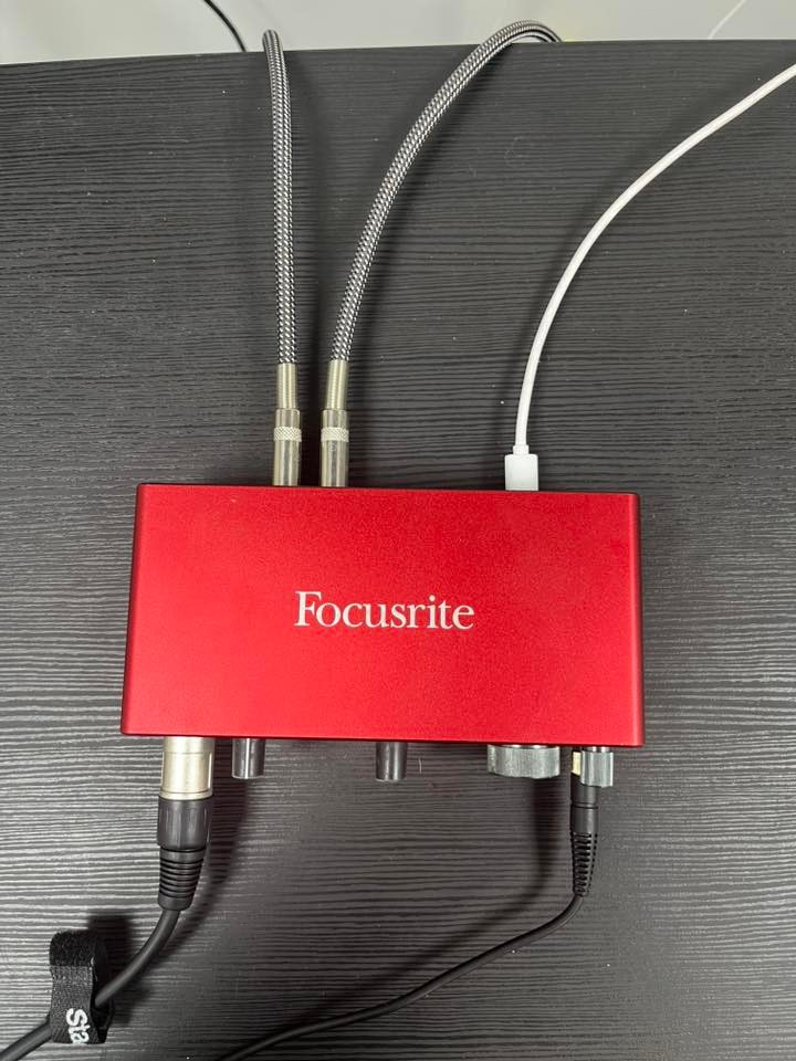 Red Focusrite Scarlett interface with XLR and monitor cables at Warrington Music Studio