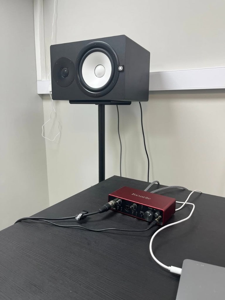 Focusrite Scarlett interface and Yamaha nearfield monitor on a desk at Warrington Music Studio.